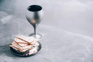 A Cup of wine and matzah unleavened bread for the passover seder event