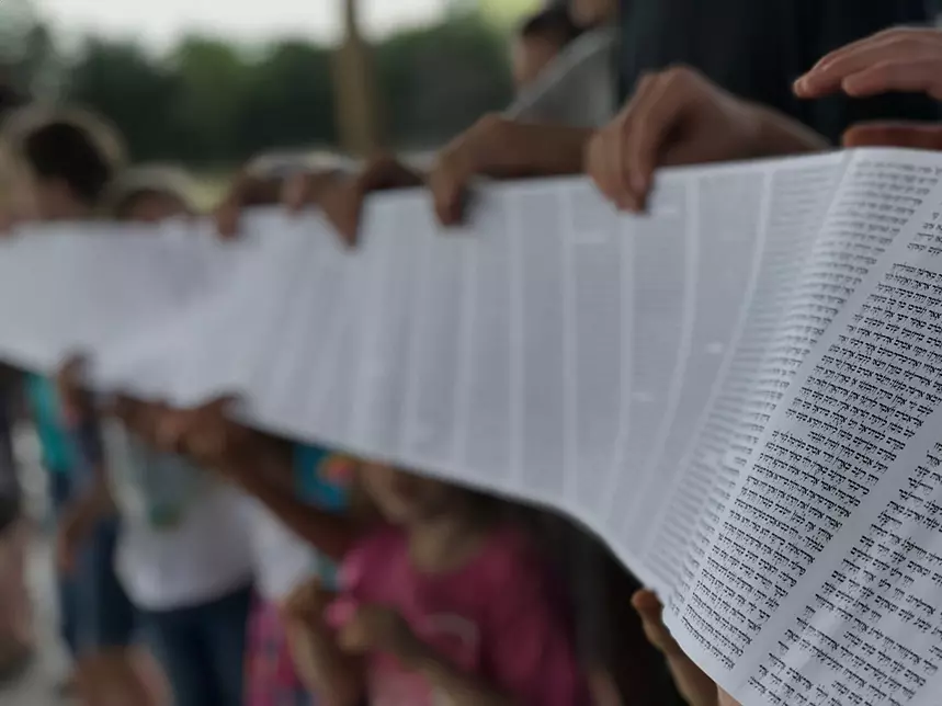 church members holding Torah scroll